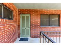 Exterior view of a brick condo building showing the front door entrance and windows at 91 Rumson Ne Rd # B25, Atlanta, GA 30305