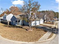Charming home with a two-car garage, mature trees, and a well-manicured lawn at 2540 Park Ave, Austell, GA 30106
