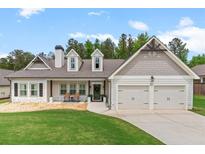 Charming home with a well-manicured lawn, inviting front porch, and a two-car garage at 31 Copper Leaf Ct, Villa Rica, GA 30180