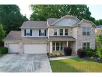 Charming two-story brick home with a three-car garage and manicured front yard at 139 Vinca Cir, Suwanee, GA 30024