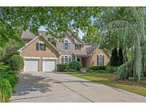 Charming two-story home with a stone facade, manicured lawn, and a two-car garage at 2595 Glaramara Ter, Cumming, GA 30041