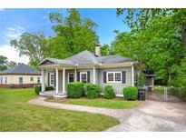 Charming single-story home with a welcoming front porch and manicured landscaping at 3288 Dogwood St, Atlanta, GA 30337