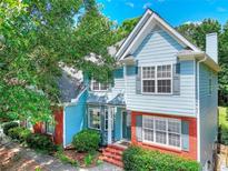 Charming two-story home with blue siding, brick accents, and a well-manicured front yard at 662 Shady Willow Ln, Loganville, GA 30052