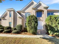 Charming two-story brick home boasts well-manicured landscaping and a welcoming entrance at 2577 Ozella Sw Pl, Atlanta, GA 30331