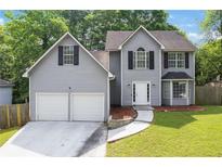 Charming two-story home with a two-car garage and a well-manicured lawn at 2907 Oakvale Falls Dr, Decatur, GA 30034