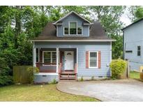 Charming home with a covered front porch, neat yard, and light blue exterior at 3111 Jones St, East Point, GA 30344