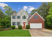 Charming two-story home with gray siding, brick accents, and a well-manicured front lawn at 111 Trellis Ct, Acworth, GA 30101