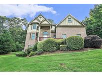 Charming two-story brick home with manicured landscaping and a welcoming front porch at 3641 Mountain Cove Rd, Snellville, GA 30039
