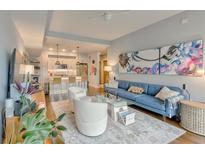Bright living room with hardwood floors, modern decor, and an open floor plan flowing into the kitchen at 1100 Howell Mill Nw Rd # 312, Atlanta, GA 30318