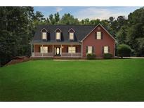 Charming two-story home with a well-manicured lawn and inviting front porch at 239 Berry Rd, Mcdonough, GA 30252