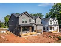 A modern two-story home showcases a gray exterior, complementing its newly constructed neighbor at 272 1St Ave, Avondale Estates, GA 30002