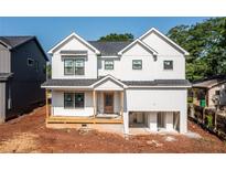 Charming two-story home with white siding, black framed windows, and a welcoming front porch at 278 1St Ave, Avondale Estates, GA 30002