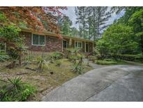 Charming brick home with a long driveway and unique landscaping creating great curb appeal at 648 Cativo Sw Dr, Atlanta, GA 30311