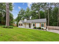Charming renovated cottage with beautiful lawn, trees and updated features at 232 Apple Branch Dr, Woodstock, GA 30188