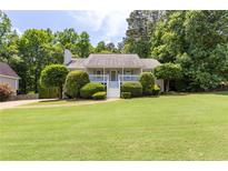 Charming single Gathering home featuring a landscaped yard, front porch, and trimmed bushes at 6275 Cheatham Lake Nw Dr, Acworth, GA 30101