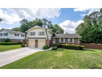 Charming two-story home featuring a well-manicured lawn and an attached two-car garage at 4205 Jeri Lynn Ct, Tucker, GA 30084