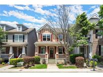 Charming two-story townhome with inviting front porch and well-maintained landscaping at 1744 Habershal Nw Dr, Atlanta, GA 30318