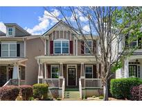Charming home featuring a cozy front porch and tasteful red shutters, enhanced by well-maintained landscaping at 1744 Habershal Nw Rd, Atlanta, GA 30318