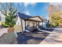 Charming home boasts a covered front porch and freshly mulched landscaping in a tranquil setting at 923 Smith Sw St, Atlanta, GA 30310
