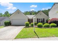 Charming one-story home with lush landscaping, inviting curb appeal, and a two car garage at 2125 Mina Lane Dr, Buford, GA 30518