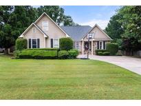 Charming single-Gathering home with manicured lawn and basketball hoop on driveway at 2835 Channing Way, Cumming, GA 30040