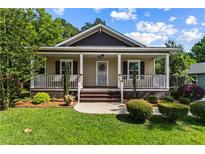Charming single Gathering home with a cozy front porch and well-manicured lawn at 1751 Thomasville Se Dr, Atlanta, GA 30315