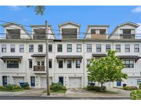 Modern townhome row boasts clean white facades, upper-level decks, and convenient garage access at 1192 Wylie Se St # 429, Atlanta, GA 30316