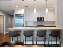 Modern kitchen features a large quartz countertop island with pendant lighting and stainless steel appliances at 270 17Th Nw St # 2210, Atlanta, GA 30363