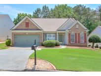 Charming single-story home with a well-manicured lawn and brick exterior, enhancing curb appeal at 935 Santa Anita Dr, Woodstock, GA 30189