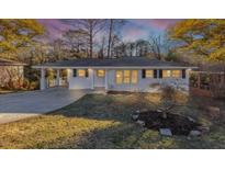 Charming single-story home features a covered carport and well-maintained front yard landscaping at 2480 Miriam Ln, Decatur, GA 30032