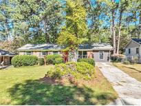 Charming single-story home with a brick facade and lush landscaping at 4639 Tell Sw Rd, Atlanta, GA 30331