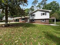 Charming two-story home with a brick facade and a well-maintained lawn at 6389 Cumberland Dr, Rex, GA 30273