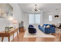 Bright living room features hardwood floors, stylish lighting, and comfortable seating at 800 Peachtree Ne St # 101, Atlanta, GA 30308