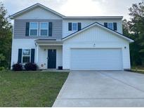 Charming two-story home with a large two car garage and a well maintained lawn at 30 Sloane Ct, Covington, GA 30016
