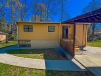 Charming single-story home featuring a covered parking area and walkway at 3082 Dove Way, Decatur, GA 30033
