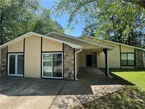 Inviting single-story home with a covered carport and stone accents at 120 Squirrel Way, Atlanta, GA 30349
