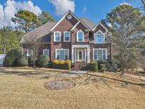 Charming brick two-story home with manicured lawn and mature trees at 101 Lumby Ln, Stockbridge, GA 30281
