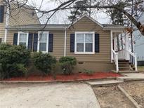 Charming single-story home with tidy landscaping and a quaint front porch at 6448 Charter Way, Lithonia, GA 30058