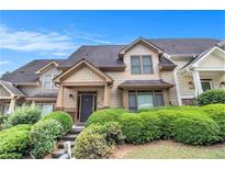 Charming townhome exterior with well-maintained landscaping and inviting entrance at 2551 Village Creek Se Lndg, Atlanta, GA 30316