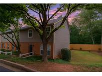 Charming townhouse with a mix of brick and siding, complemented by mature trees and a well-maintained lawn at 7750 Roswell Rd # 3D, Atlanta, GA 30350