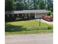 An exterior view of the property with a red dumpster and an attached garage at 1024 Topaz Lane, Villa Rica, GA 30180
