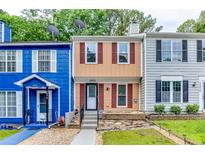 Charming townhome featuring red shutters, and well-manicured landscaping, and convenient front entrance at 2972 Aspen Woods Entry, Atlanta, GA 30360