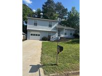 Charming two-story home with a well-maintained lawn and driveway, offering comfortable living at 851 Shore Dr, Lithonia, GA 30058