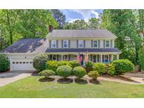 Charming two-story home with well-manicured landscaping and a classic colonial facade at 905 Foxfire Dr, Lawrenceville, GA 30044