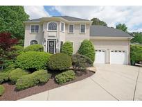 Charming two-story home with manicured landscaping and attached two-car garage at 5617 Asheforde Ln, Marietta, GA 30068