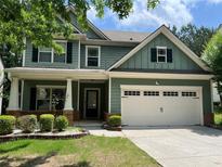 Charming two-story home with green siding, white trim, a well-maintained lawn, and a two-car garage at 519 Granite Nw Ct, Lawrenceville, GA 30044