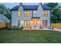 A modern home featuring a rear exterior with a well-maintained lawn and a gray trim at 2809 Glenwood Se Ave, Atlanta, GA 30317