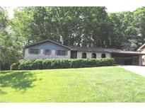 Charming brick home featuring a well-manicured lawn and a convenient carport at 4747 Darlene Way, Tucker, GA 30084