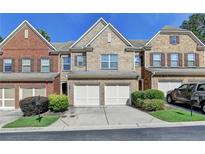Charming townhome with brick facade, two-car garage, and well-maintained landscaping at 3351 Vintage Se Cir, Smyrna, GA 30080