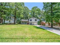 Charming home featuring a well-maintained lawn, mature trees, and inviting curb appeal at 1934 Patton Pl, Lithonia, GA 30058
